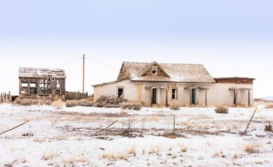 Fototapeta na wymiar Abandoned adobe with out building, in snow, Costilla, NM
