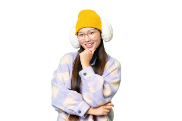 Young Asian woman wearing winter muffs over isolated chroma key background with glasses and smiling
