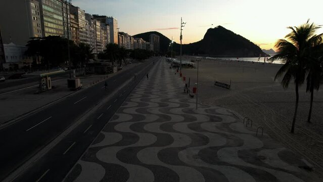 Aerial view of famous Copacabana Beach boardwalk with its way mosaic in Rio de Janeiro, Brazil at dusk