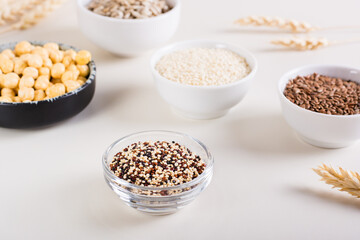 Quinoa mix in a bowl and other seeds in bowls on the table. Healthy food.