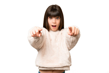 Little girl over isolated green chroma key background surprised and pointing front