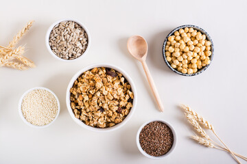 Baked granola in a bowl and different seeds in bowls on the table. Healthy breakfast. Top view