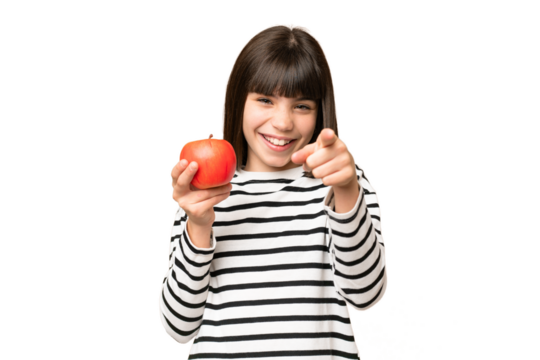 Little girl with an apple over isolated chroma key background points finger at you with a confident expression - Powered by Adobe