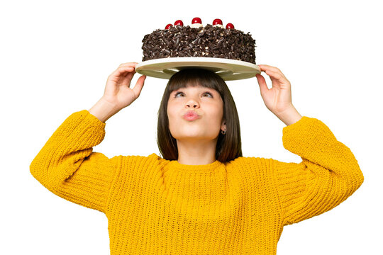 Little girl holding birthday cake over isolated chroma key background