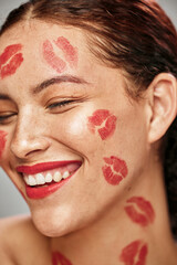 Happy woman, red lipstick and makeup on face of skin model in studio for cosmetics and love....