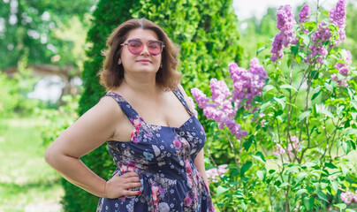 Fototapeta premium Plus size European mature woman in stylish romantic women's clothes dress. Concept of sizes, happy nice natural beautiful lady 