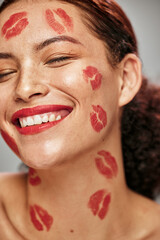 Face, red lipstick kiss and makeup on face model woman in studio for cosmetics and happiness....