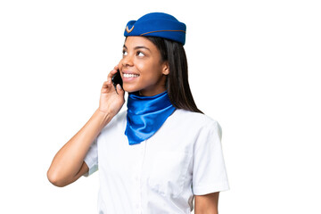 Airplane stewardess African american woman over isolated background keeping a conversation with the mobile phone