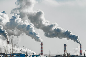 industrial chimneys with heavy smoke causing air pollution