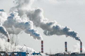 industrial chimneys with heavy smoke causing air pollution