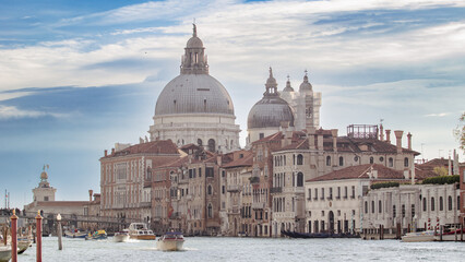 Beautiful panorama of venice at sunrise. Boats sailing along the canals of Venice between private...