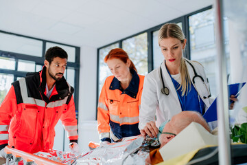Young woman doctor taking care of patient from rescue ambulance.