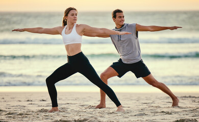 Warrior pose, couple and beach yoga at sunset for health, fitness and wellness. Exercise, zen chakra and man and woman stretching, training and practicing pilates for balance outdoors at seashore.