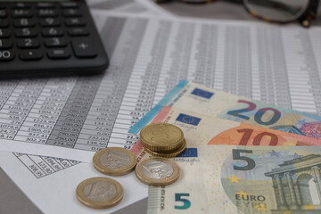 Euro and еuro coins lying on the financial schedule