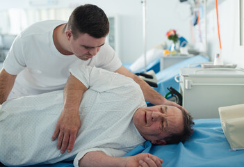 Young man with down syndome working in hospital as caregiver. Concpet of integration people with...