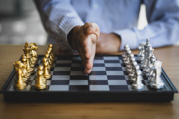 Businessman stopping game on chess board. Concept of organizational management and stop conflict.