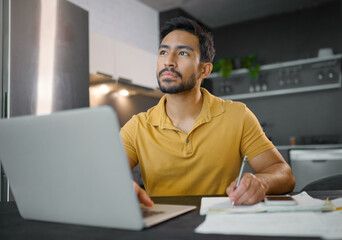Laptop, writing and thinking with a freelance man doing remote work from home on research in his...