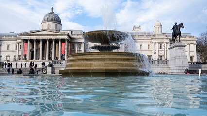 Fountain in Trafalgar Square London, with fountain in foreground and art galleries behind