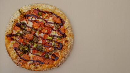 Delicious pizza with smoked sausage, cheese and BBQ sauce on a close-up sound. minimalism, street food 