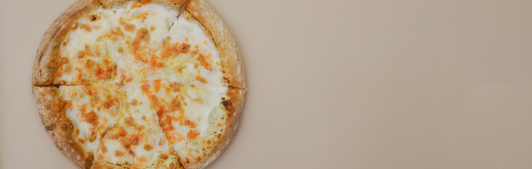 delicious cheese pizza lying on a beige close-up background, banner backdrop