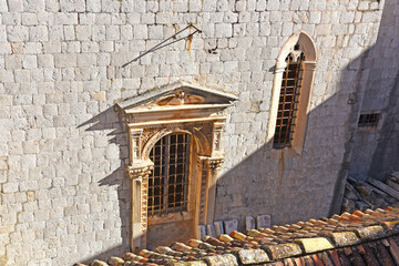 view to the Dominican Monastery with classic red tiled rooftops inside the old town of Dubrovnik,...