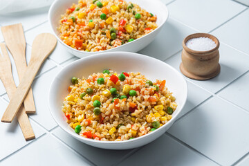 Bulgur with vegetables in a white plate close-up