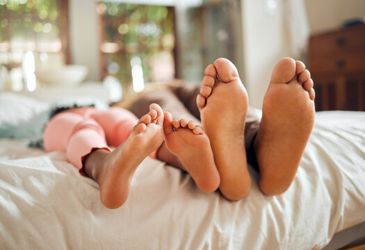 Family, bed and feet of father and girl enjoying quality time, holiday and freedom on weekend together. Love, home lifestyle and dad with child in bedroom to relax, bonding and happiness in morning