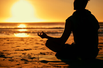 Meditation, lotus and silhouette of man at beach outdoors for health and wellness. Sunset, zen yoga...