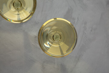 Sparkling Champagne in a Coupe Glass on a gray background, top view. Flat lay, overhead, from above.