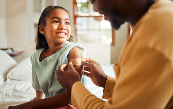 Injury, father and arm bandage for girl after accident in bedroom. First aid, black family and man apply bandaid or plaster on wound of hurt or injured child for wellness, recovery and healthcare.