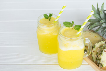 Pineapple smoothies yellow colorful fruit juice milkshake blend beverage healthy high protein the taste yummy In glass,drink to lose weight drink episode morning on white gray background.
