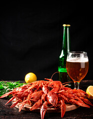 Boiled crayfish with a glass of beer and lemon. 