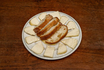 A generous tapa of Galician tetilla cheese sliced with slices of village bread
