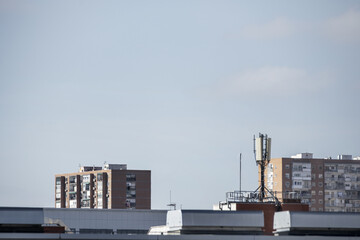 View of facades and roofs of the city with TV antennas, telephones and lightning rods