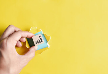 Chart icon hiding of yellow punched paper, business for planning business objective target to successful development, innovation, idea, creative.
