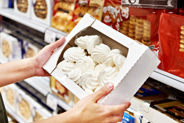 Pack of marshmallow in hands of buyer