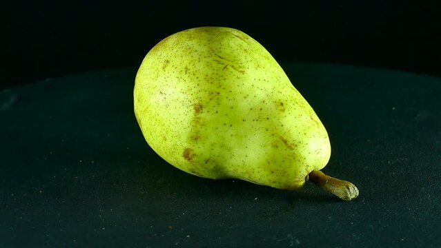 Green pear spinning in studio