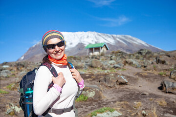 Naklejka na ściany i meble Female backpacker on the trek to Kilimanjaro mountain.