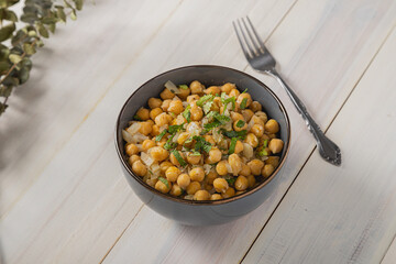 Bowl of cooked chickpeas in soft light
