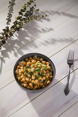 Bowl of cooked chickpeas with white background