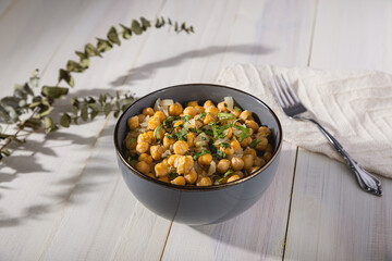 Bowl of cooked chickpeas with white background