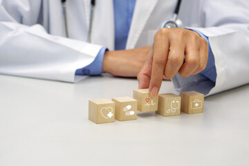 Hand holding a wooden block cube the top one with heart rate icon symbol. Medical and health concept.