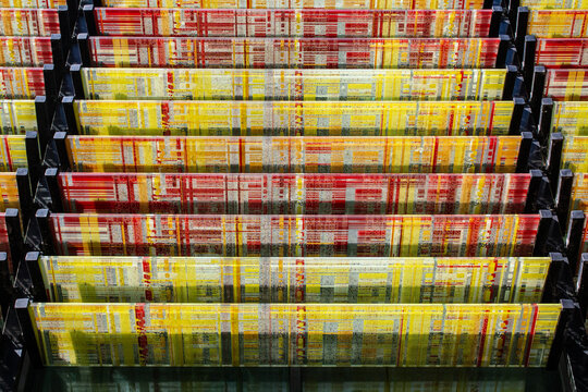 A building outdoor shades made of red and yellow glass blades