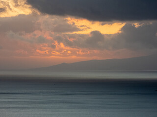 Sunset between red clouds on the horizon