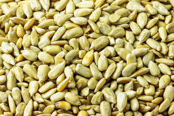 Top view of sunflower seeds without husk as background
