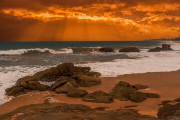 beautiful sunset over the indian ocean with rocks in the foreground sri lanka