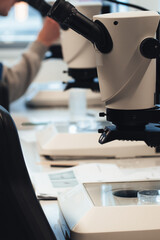 Close up shot of microscopes in a laboratory with scientist working in the background