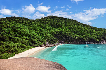 Beautiful tropical landscape of lush lagoons in the Similan Islands with a sailboat 