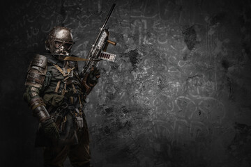 Shot of post apocalyptic soldier with uniform and shotgun dressed in armor and gas mask.