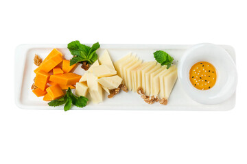 Cheese plate with nuts and honey. Traditional popular snack. Top view. Isolated on white background.